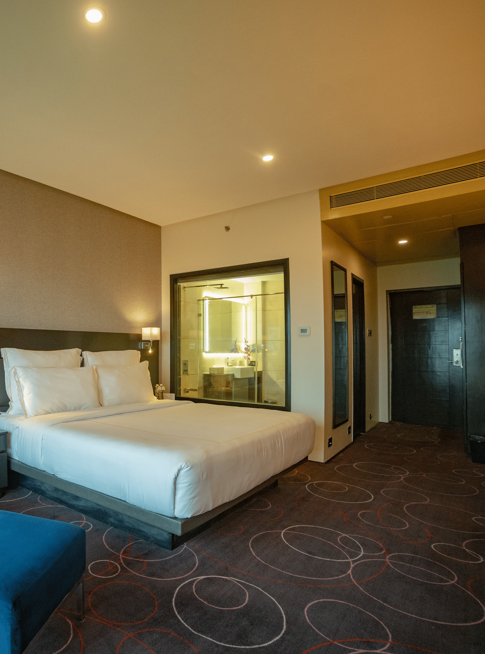 Spacious suite with elegant furnishings and cosy ambience at Narayani Heights Hotel & Resorts, Ahmedabad.