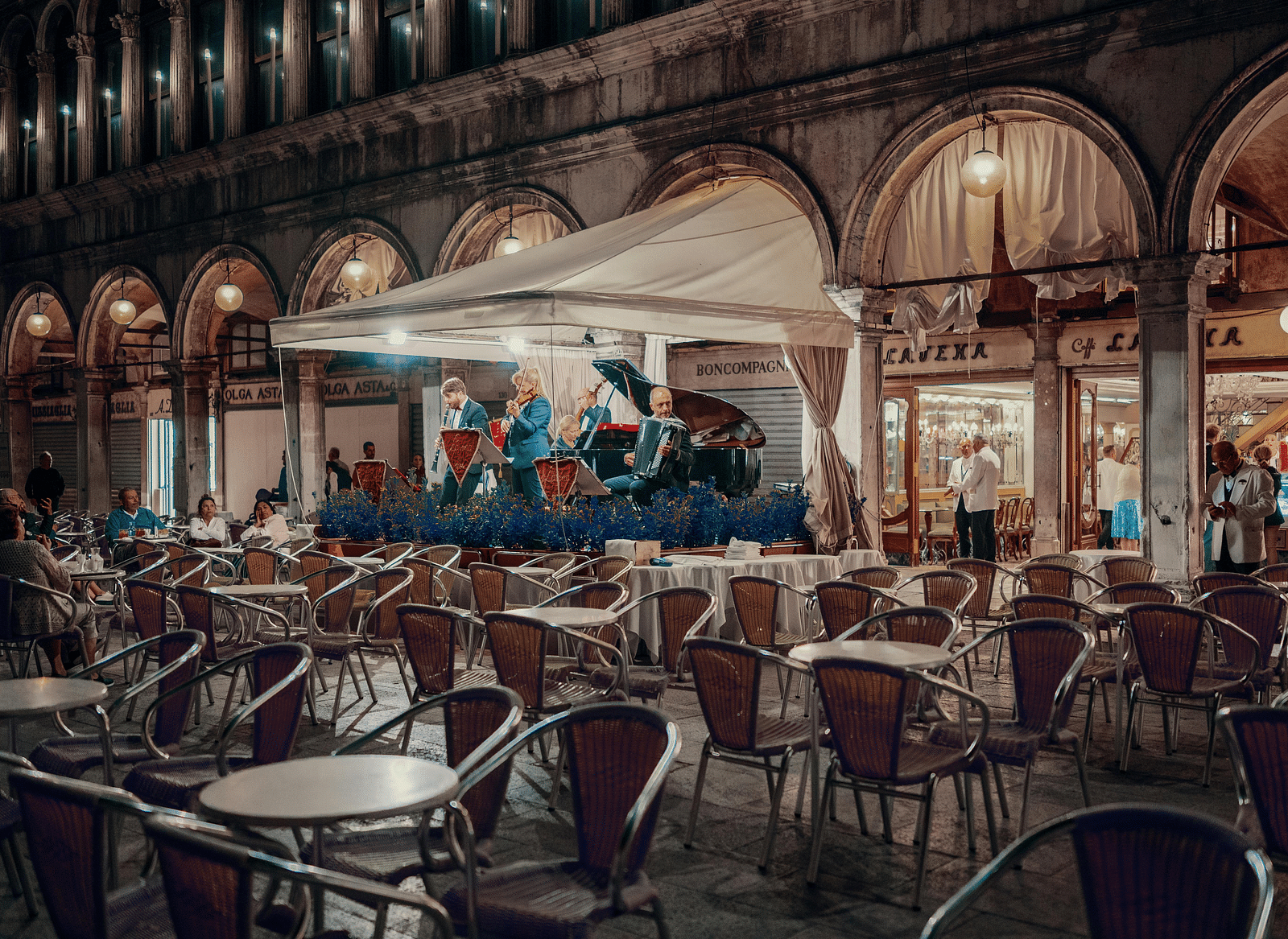A restaurant with a small group of people playing instruments.