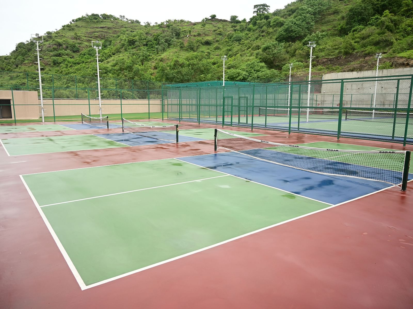 image of the tennis courts at club chraholi with a lowered net separating the two sides of the court