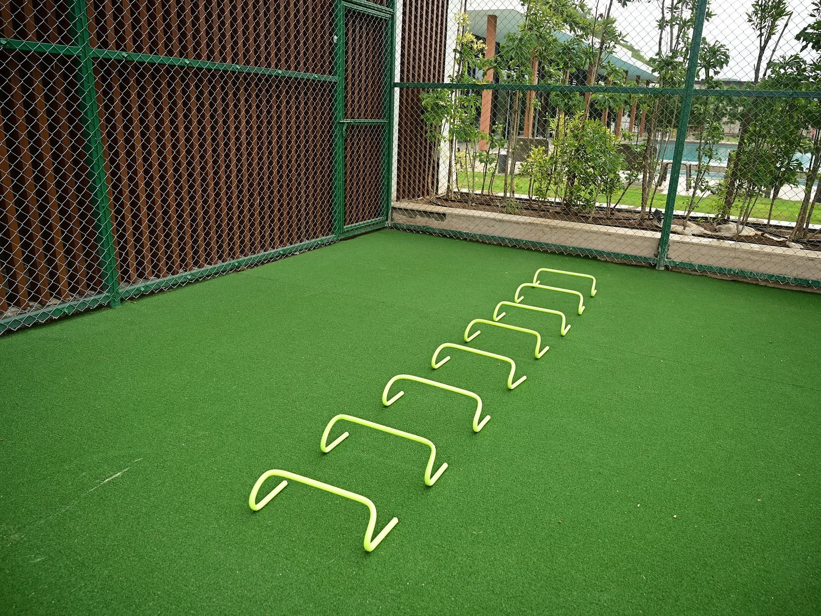 image of the hurdles lined up on a fake grass tarmac at club charholi, Pune