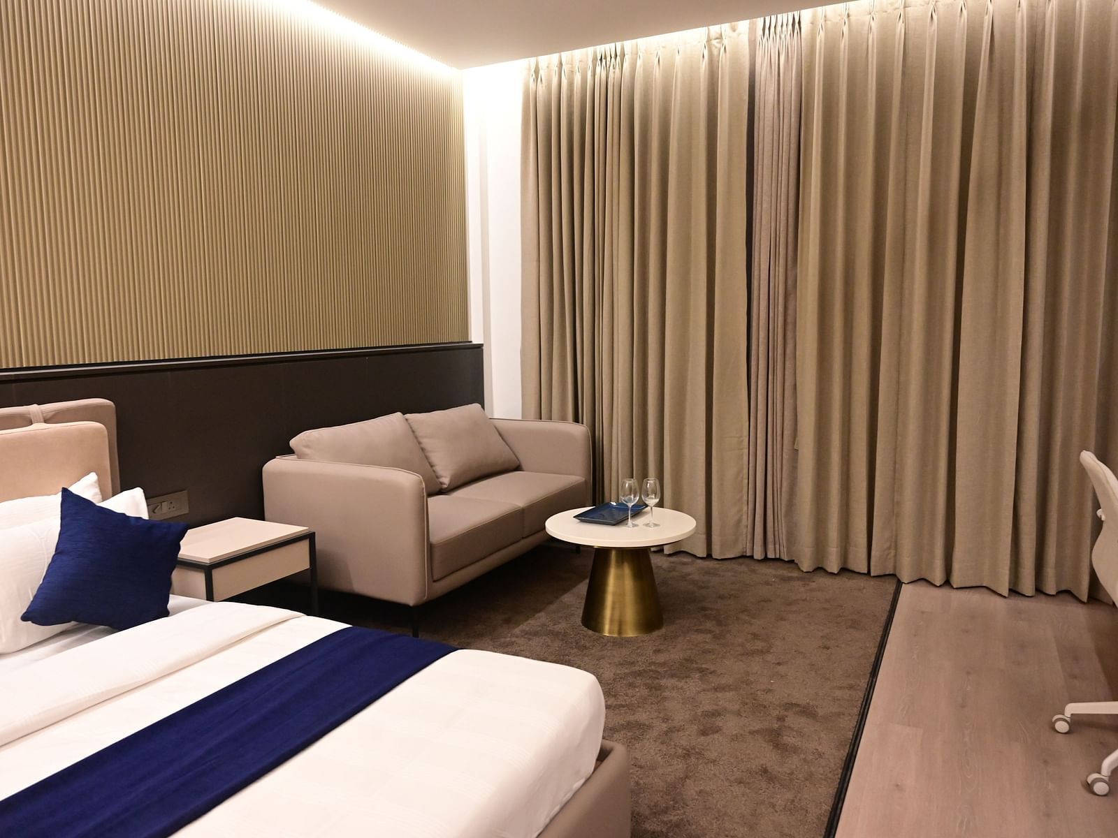 image of the imperial guest suite at club charholi with a double bed and a seating area in the corner