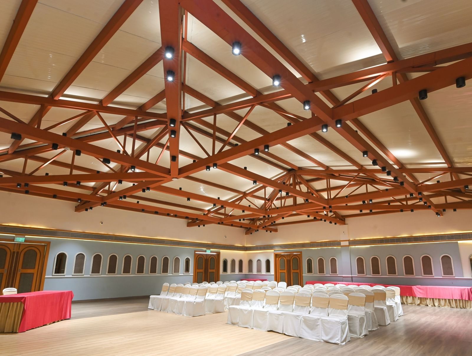 OM I with  with exposed wooden beams and banquet seating at Vedic Village Spa Resort.