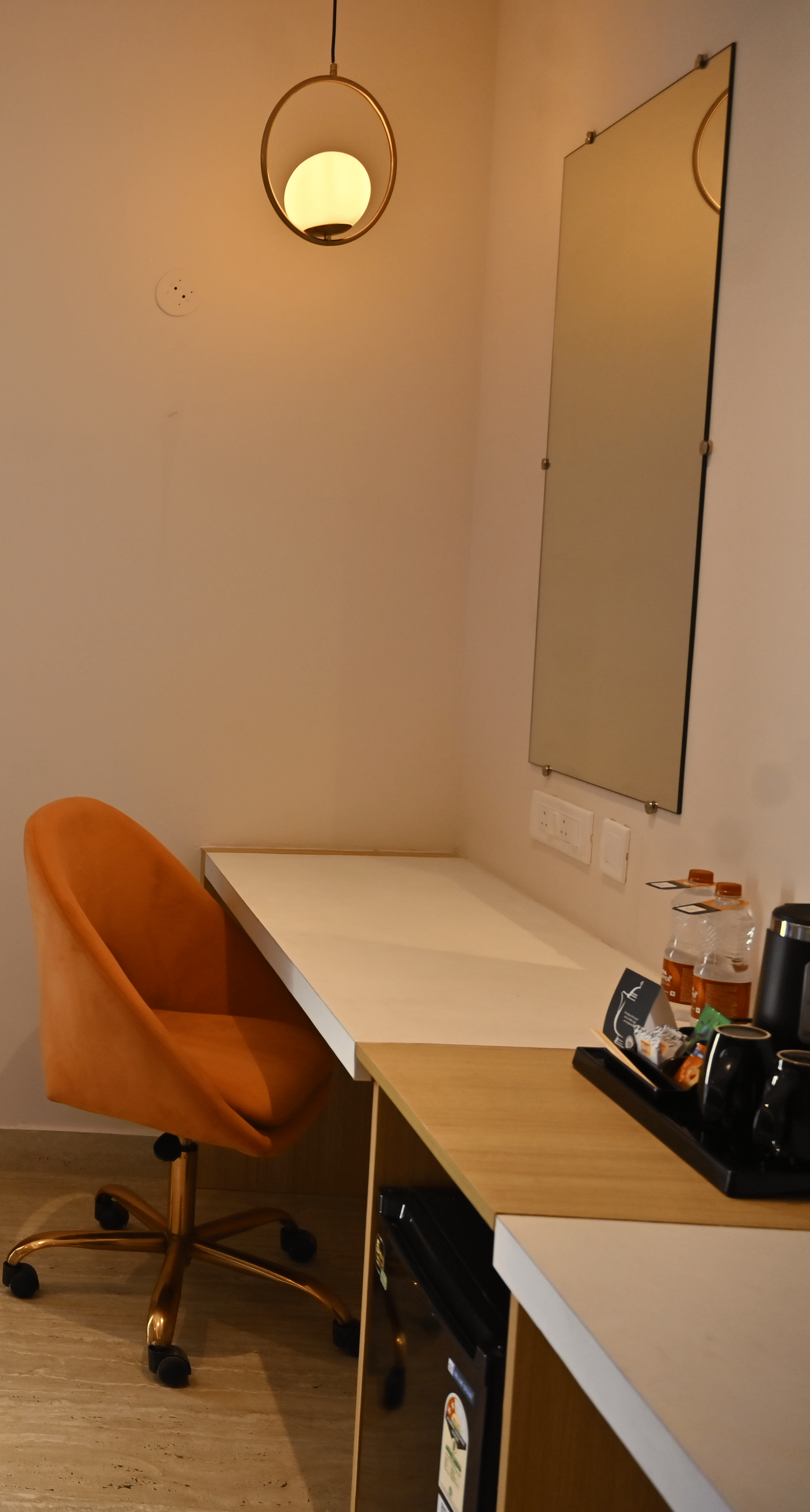 Premium room corner with a chair, a small glass table, and a desk near a sliding door that opens to a private balcony at TGI Livancia Hillside