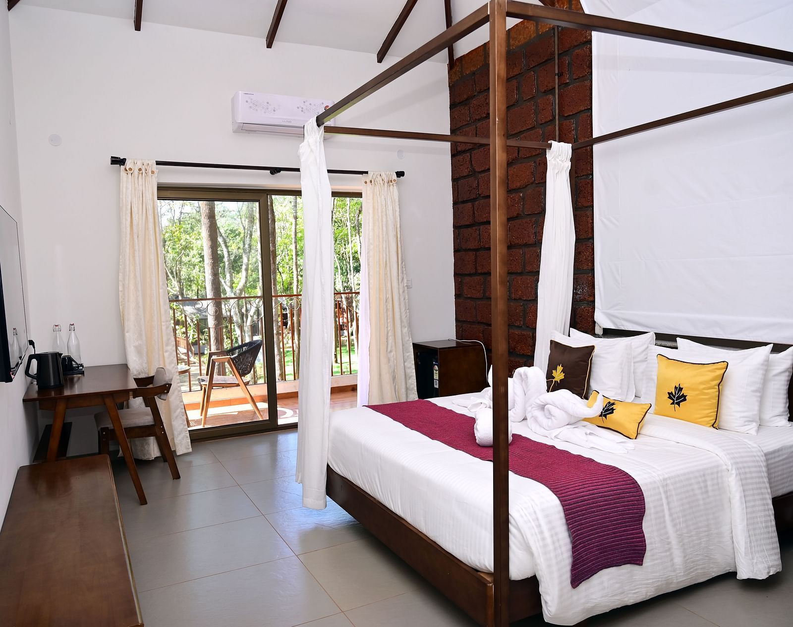 An image of a Premium Cottage featuring a poster bed, a flat TV screen, a work desk and chair, and a balcony - TGI Redolent Resort, Kushalnagar, Coorg