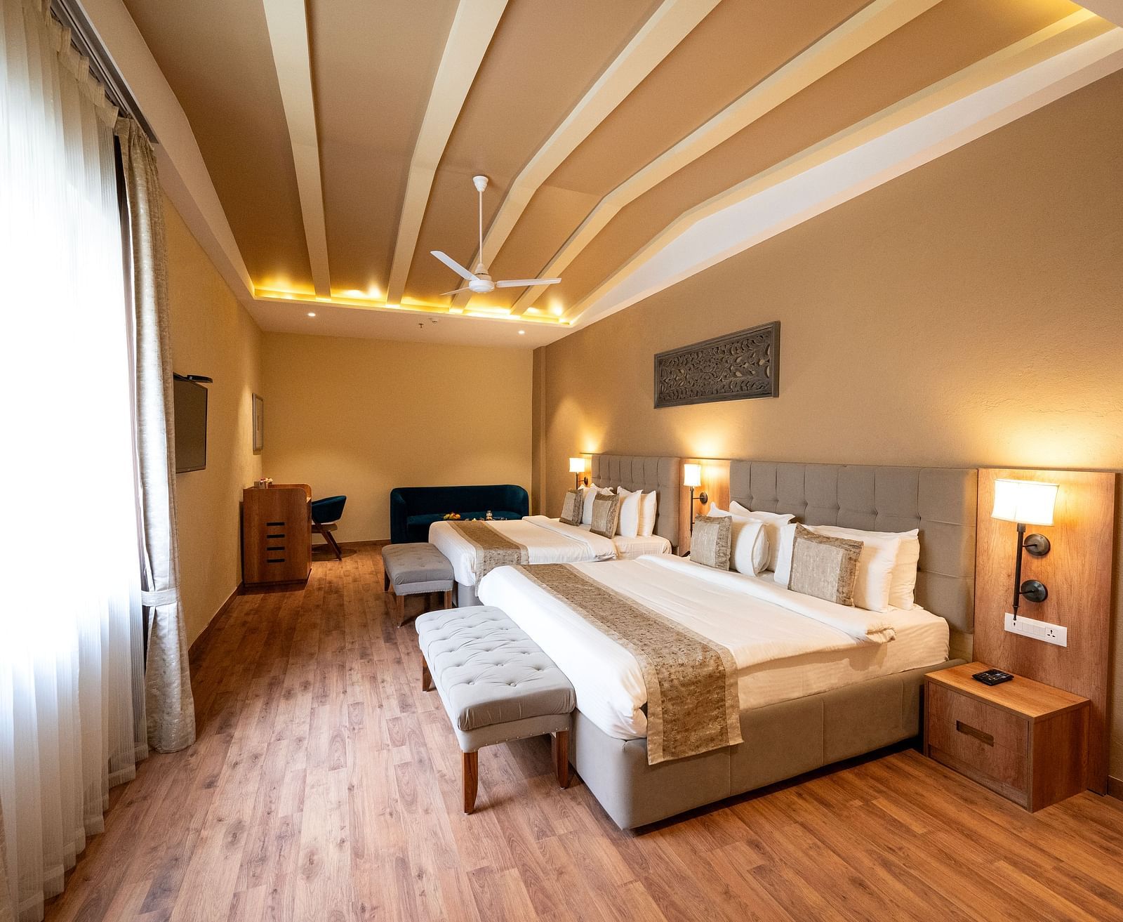 Studio quad bed room at Essentia Luxury Resort & Spa, Udaipur with modern interiors and a window with good lighting.
