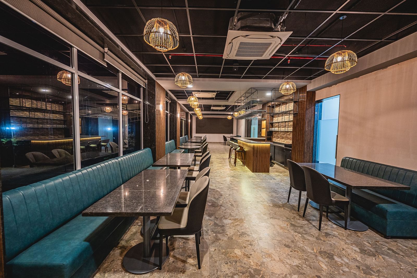 A modern restaurant with cushioned seating and a sophisticated atmosphere at Lotus Leaf Boutique Hotel.