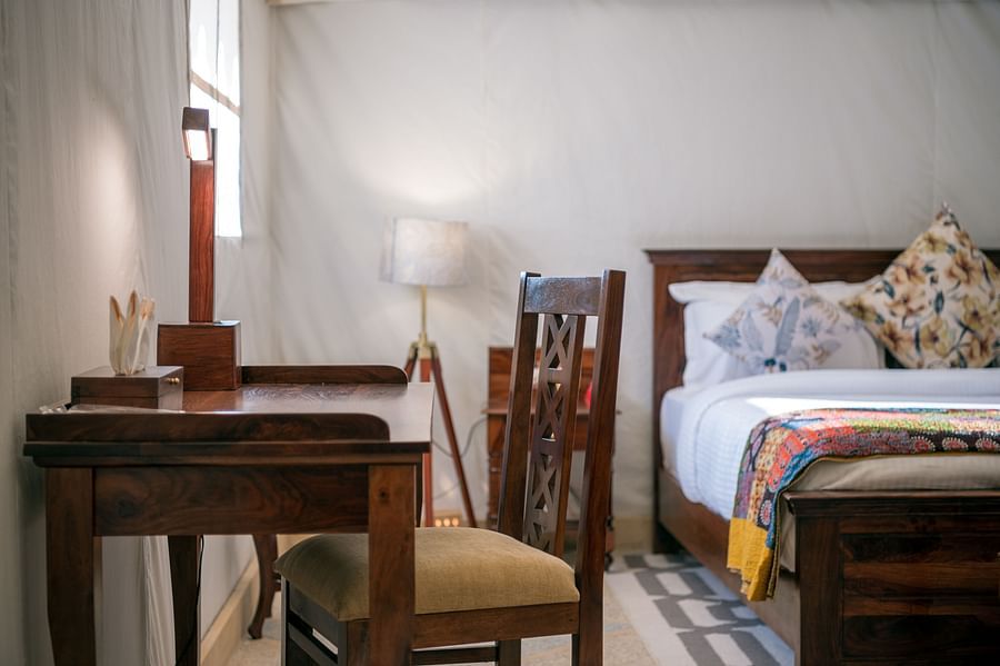 alt-text The work desk and chair placed close to the bed - Karwaan Jaisalmer