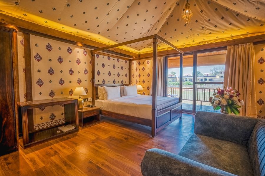 A Premium Duplex Tent featuring  a plunge swimming pool, a sofa set, with centre table, and a flight of wooden stairs at The Baagh Ananta Elite, Ranthambore