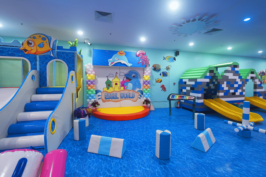 Indoor play area with slides, climbing structures, and colorful decorations, empty and ready for play.