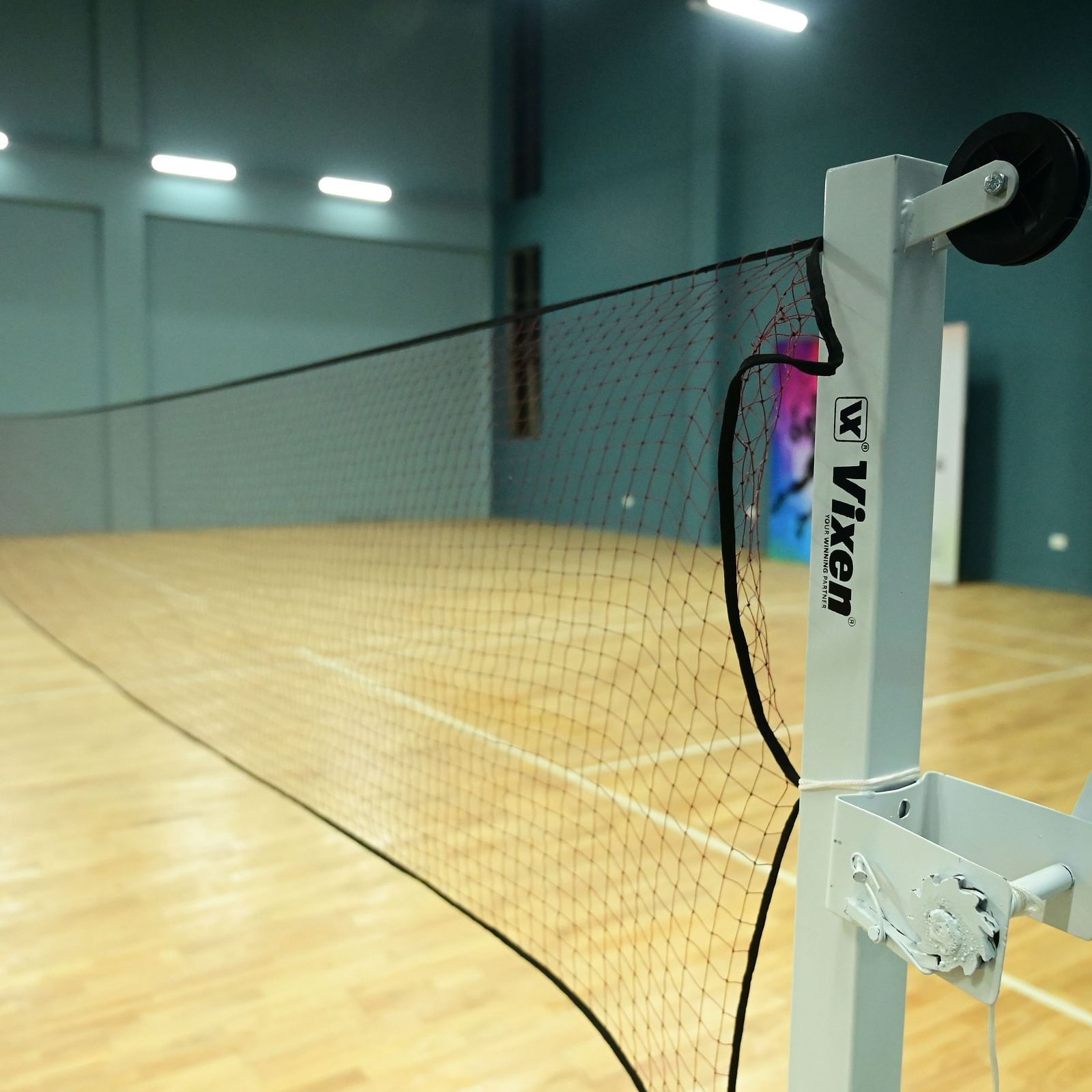 close up image of the badminton net placed in the badminton court at club charholi, pune