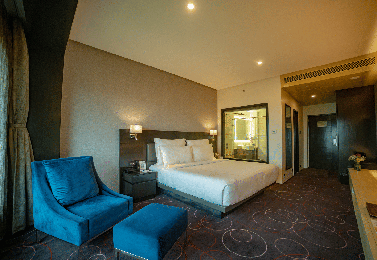 Spacious suite with elegant furnishings and cosy ambience at Narayani Heights Hotel & Resorts, Ahmedabad.