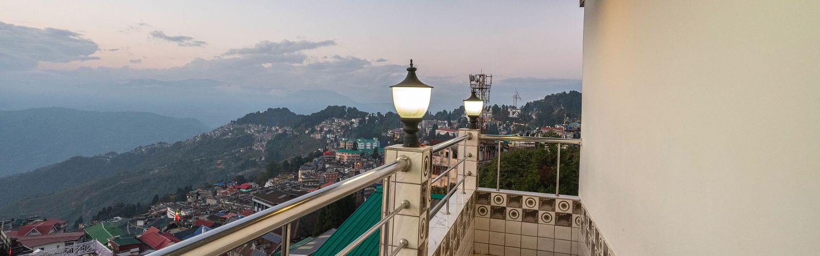 An image of side of the city view from balcony with illuminating white lights