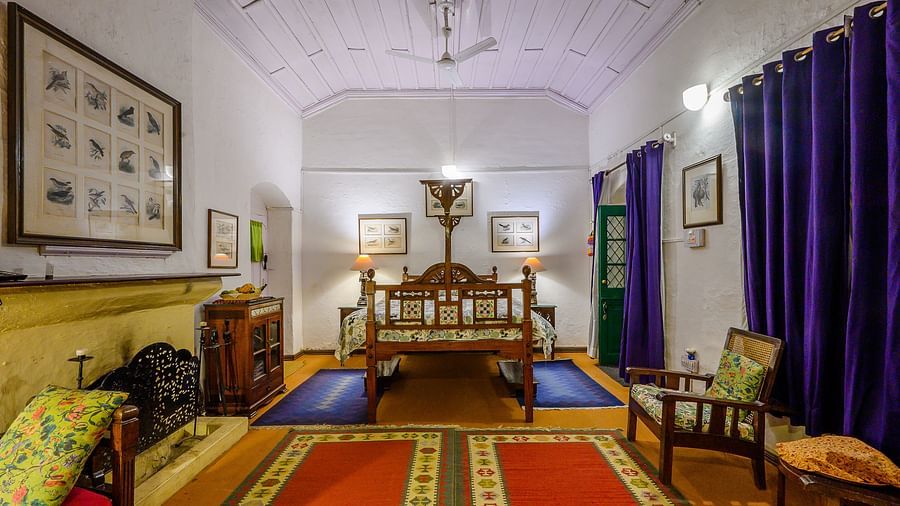 Full angle view of Bird room with one queen size bed, two couches, pristine walls, curtains and a carpeted floor - Ramgarh Bungalows, Nainital.