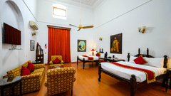 An overview of the Maharaja Rajinder Singh room with twin double beds in front of the sofas and a coffee table - The Baradari palace
