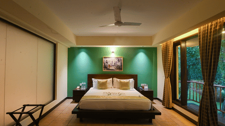 Elegant bedroom featuring a king-size bed and warm interiors at the resort.