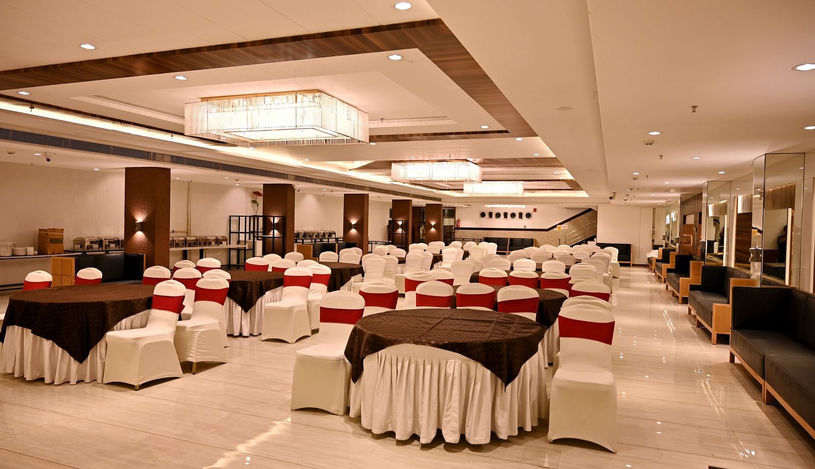 Banquet hall viewed from the end, showcasing the regal chandeliers and polished floors - TGI Insignia, Bhopal