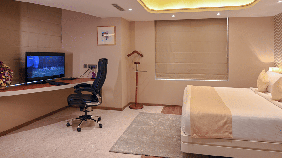 Superior Room with a work desk, office chair, and warm ceiling lighting at Dimora Hotels and Resorts, ideal for both work and relaxation.
