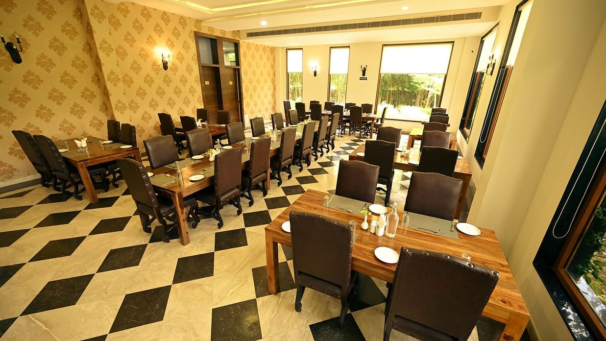 A restaurant with several tables and sofa chairs -Clarks Safari, Ranthambore