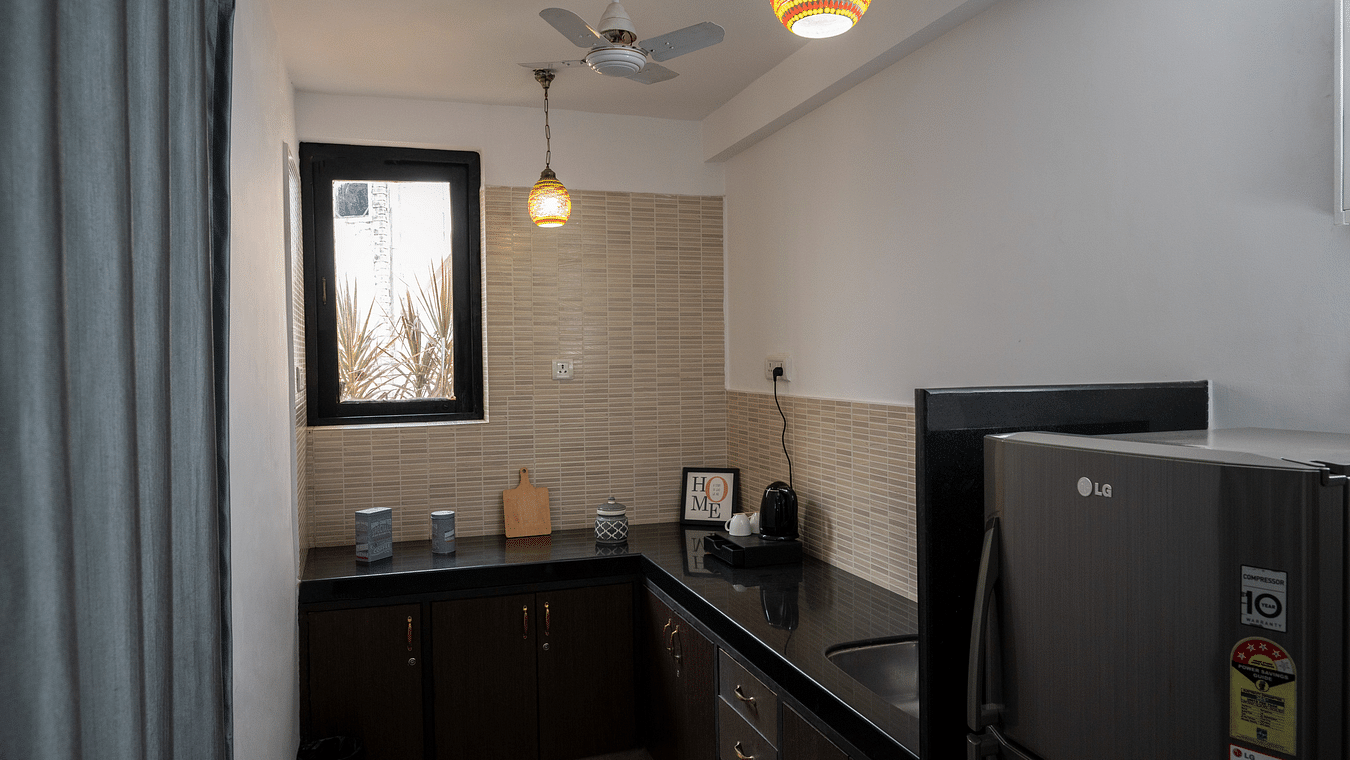 The kitchenette is equipped with the fridge and tea & coffee maker