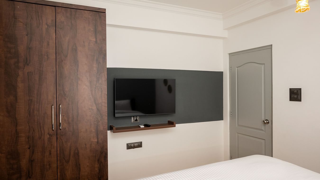 The bedroom with an LED TV, an AC and a cupboard