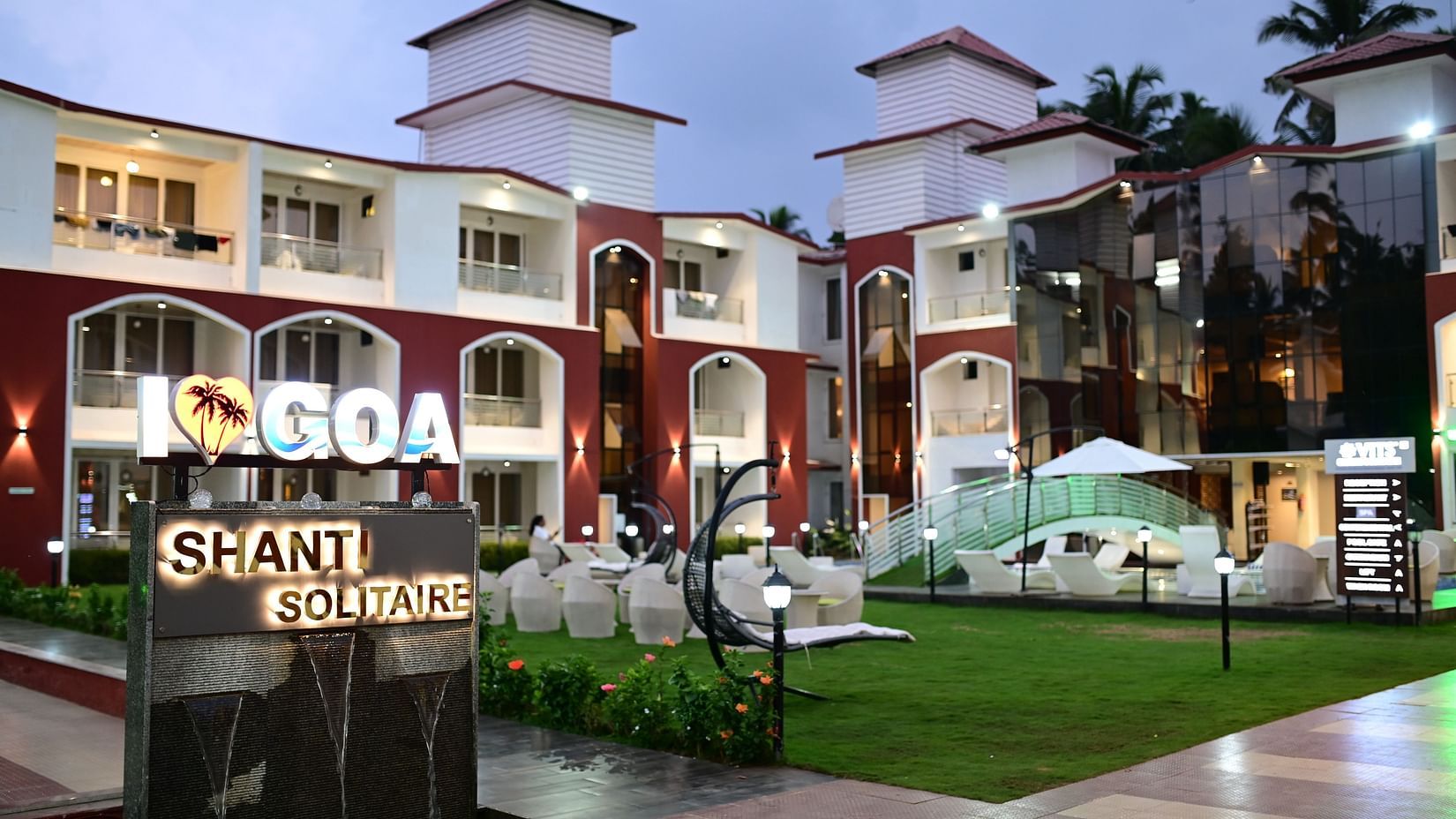 facade view of VITS shanti solitaire, North Goa with a garden and swimming pool in view
