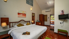 A double bed marble side table and tv inside Cassis room in Neemrana s Three Waters