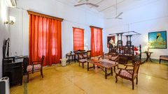 An overview of Raja Baba Ala Singh room with sofas, coffee table and king size bed at the background - The Baradari palace