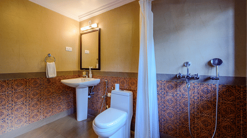 An overview of the bathroom inside Olivia - River View room at neemrana s three waters
