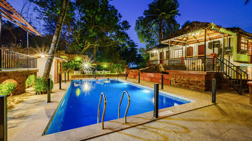 Overview of the Swimming pool with a building on the side at neemrana s three waters