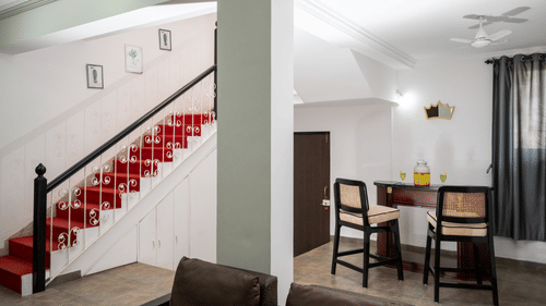 The interiors of one of the accommodations shows the dining area and the staircase - Richmonde Ananta Elite, Goa
