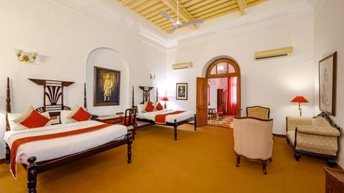 An overview of the Maharaja Bhupinder Singh room with twin double beds, sofas and an ac wall mounted - The Baradari palace
