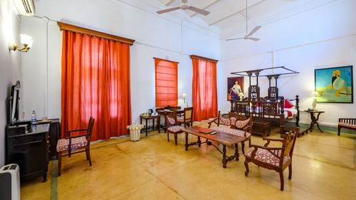 An overview of Raja Baba Ala Singh room with sofas, coffee table and king size bed at the background - The Baradari palace