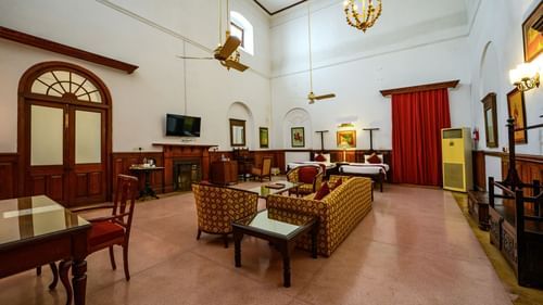 An overview of the Raja Amar Singh room with sofas, coffee table in front of the tv - The Baradari palace