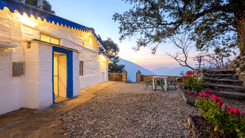 An overview of the entrance to Blue Cottage in the evening with the sun setting in the background - The Ramgarh Bungalows - 19th Century.
