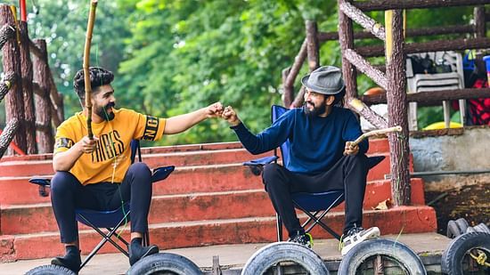two guys fist pumping and fishing in the Fish Pond - Black Thunder, Coimbatore