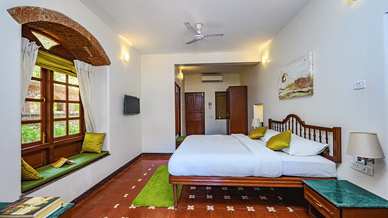 A double bed marble side table wardrobe inside Mitras - River View - River View room at neemrana s three waters