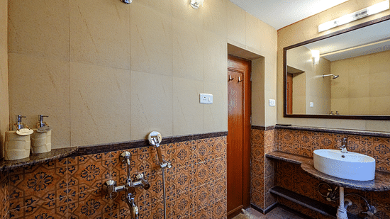 An overview of the bathroom inside Mitras - River View - River View room at neemrana s three waters