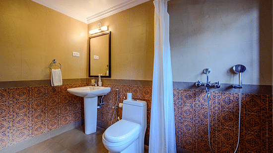 An overview of the bathroom inside Olivia - River View room at neemrana s three waters