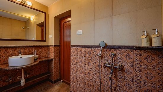 An overview of the bathroom inside Telina - River / Forest View room at neemrana s three waters
