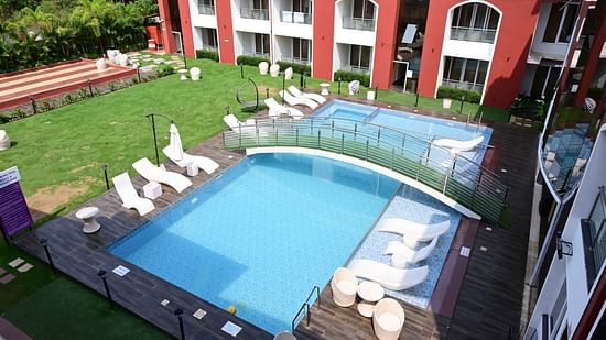 an aerial view of the swimming pool, loungers and the bridge at VITS shanti solitaire, North Goa