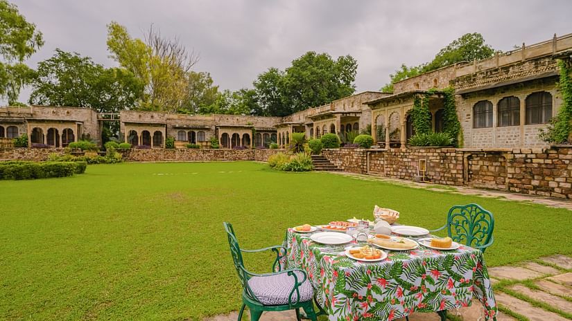 Lawn with table and chairs in front of a resort property