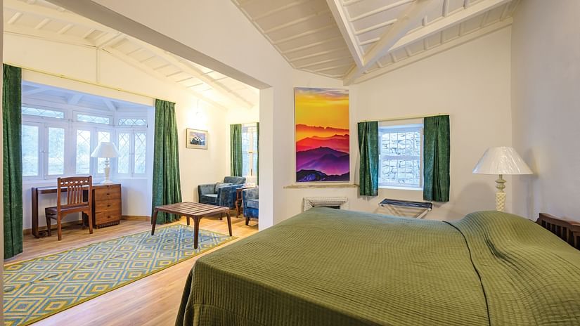 Bright room with a queen bed, flanked by windows with matching drapes. - The Ramgarh Bungalows - 19th Century, above Nainital