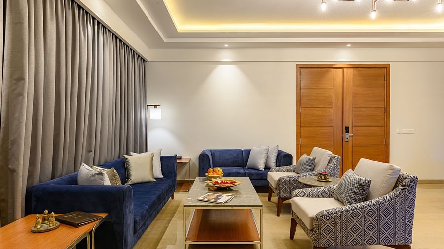 The living room of our Presidential Suites in Pushkar with  a sofa set, a television and a large window PS-4243