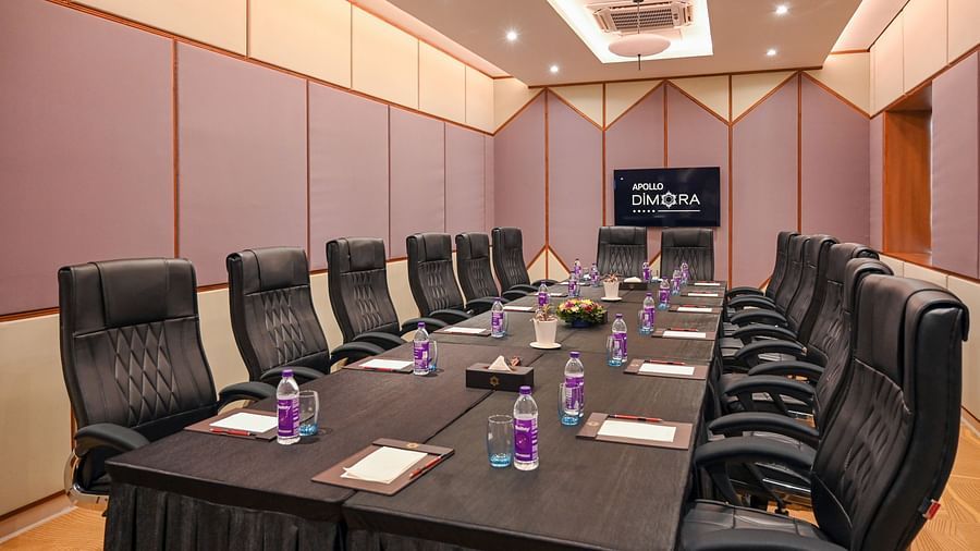 black coloured seats and a large table offered at the boardroom  2