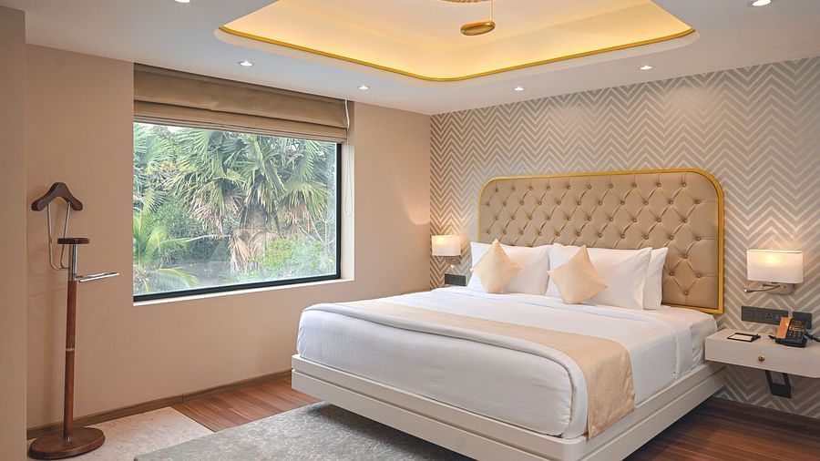 the bed at Superior Rooms in Kozhikode 1