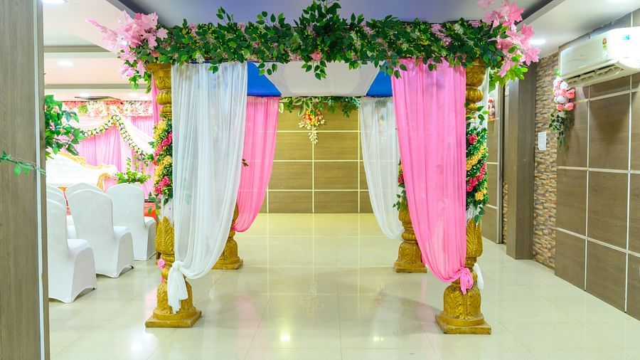 Wedding mandap beautifully decorated with flowers and draped fabric at Biznotel by Pride, Deoghar