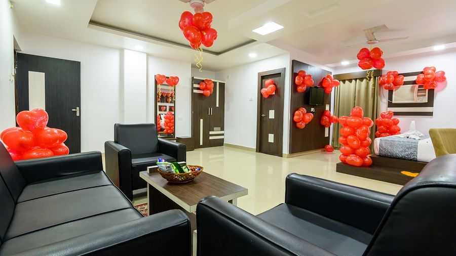 Suite Room seating area in the corner, featuring a sofa and chairs, decorated with balloons at Biznotel by Pride, Deoghar