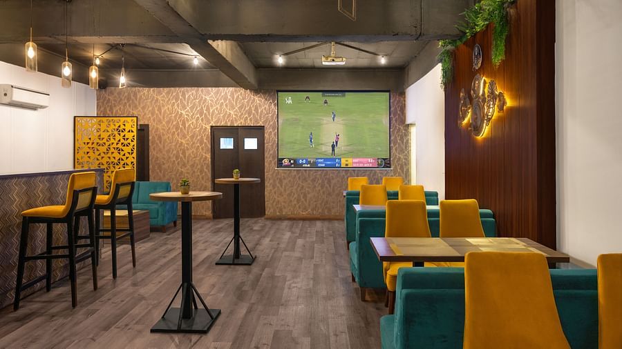 A stylish restaurant seating area with colourful chairs and tables, creating a welcoming atmosphere for diners - Clarks Inn Express, Near Jammu Bari Brahmana Railway Station