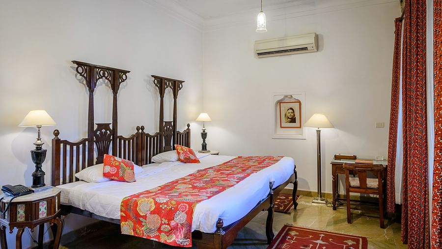 Deo Bagh - 17th Century, Gwalior - a king size bed placed beside a bedside table at the Dhruv Vilas room in Gwalior