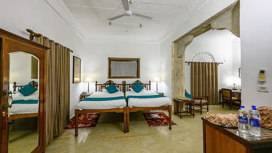 Deo Bagh - 17th Century, Gwalior - the view of the twin sharing beds and a wardrobe facing the tea and coffee making station at Mohini Mahal - Naubagh / Garden View room in Gwalior